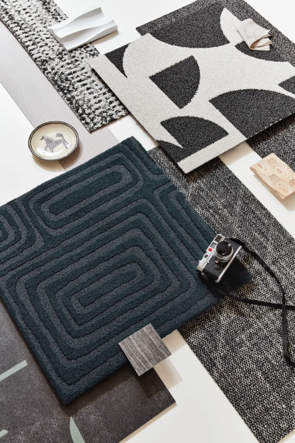 Assorted carpet swatches in black, white, and dark teal