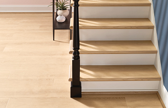 stairs with COREtec floor treads capped on each stair in a light wood tone