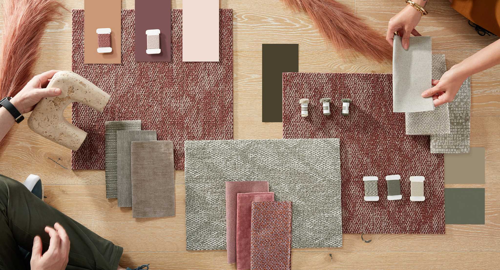 Commercial Carpet Tile Swatches with Construction Details and Dimensions 18x36 inch Carpet tile swatches in shades of red, beige, and gray with construction details, 18x36 inch dimensions, and people arranging samples on a wooden floor