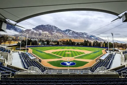 Baseball stadium with artificial turf and scenic mountain view Panoramic view of a baseball stadium with artificial turf field and mountain backdrop