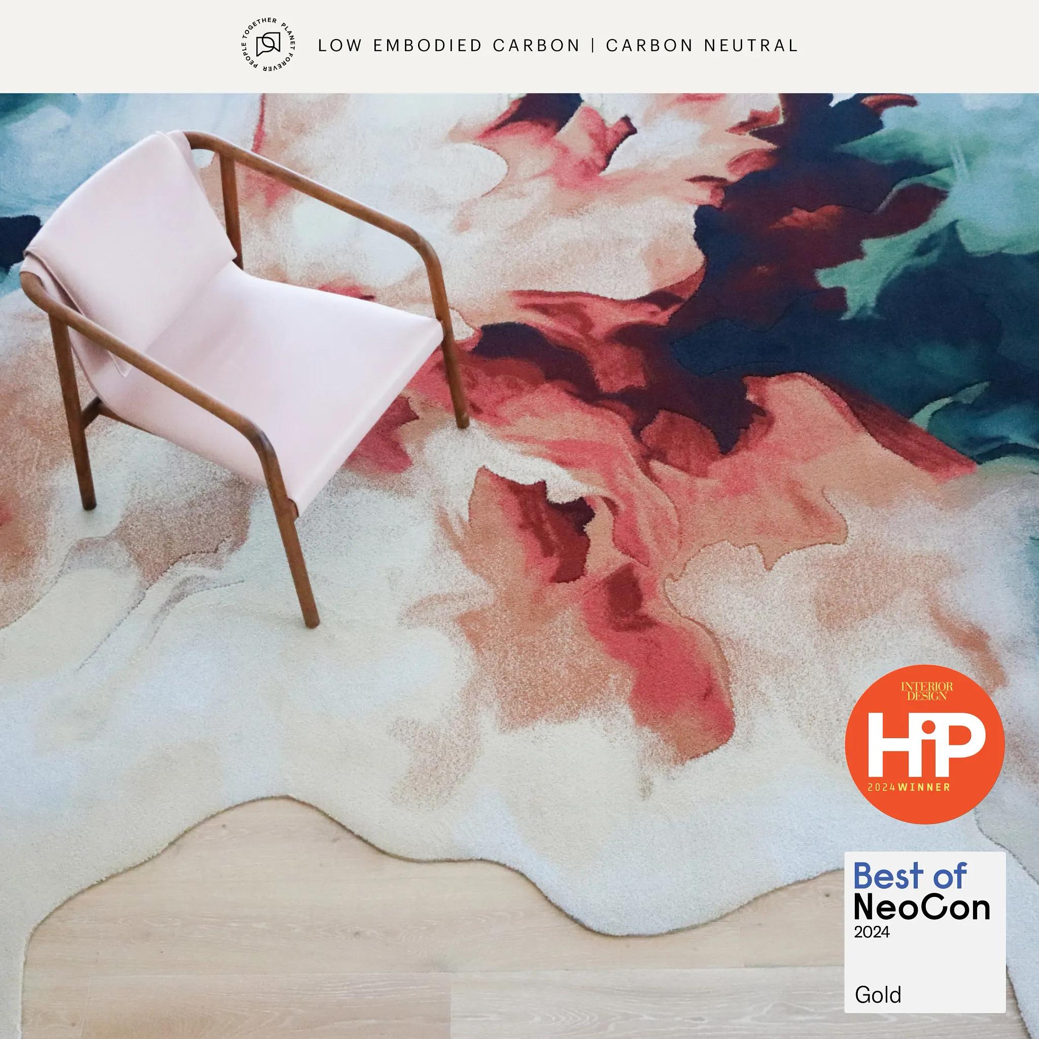 Artistic carpet design with pink, red, and blue hues in a modern setting
