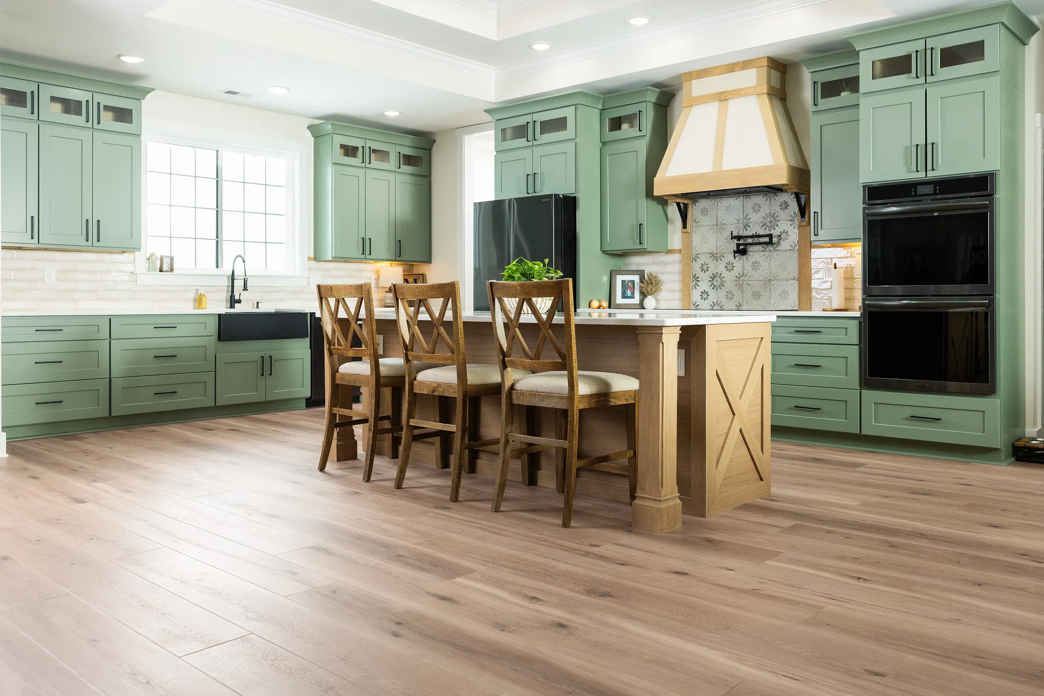 Modern kitchen with green cabinets and Coretec Residential WPC vinyl flooring