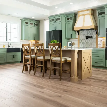 Stylish kitchen featuring durable Coretec WPC vinyl flooring Modern kitchen with green cabinets and Coretec Residential WPC vinyl flooring
