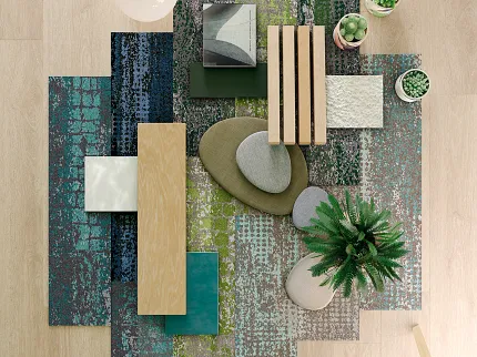 Modern room with colorful carpet tiles and light wood flooring featuring contemporary decor elements Overhead view of a modern room with a mix of colorful carpet tiles in blue, green, and gray tones, complemented by light wood flooring and contemporary decor elements including plants and a teal chair