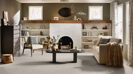 Neutral Carpet Flooring in Cozy Living Room with Modern Decor Cozy living room with neutral carpet flooring, featuring a white brick fireplace, modern furniture, and decorative elements for a warm and inviting atmosphere