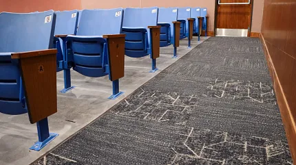 Durable commercial carpet for educational spaces Blue auditorium seating with patterned carpet in an education facility