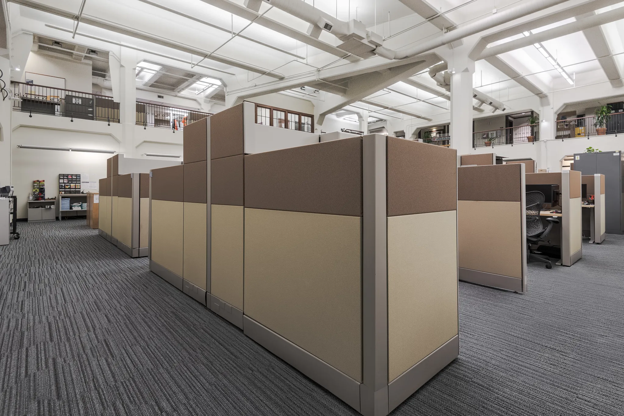 Government office space with gray carpet tile with linear design