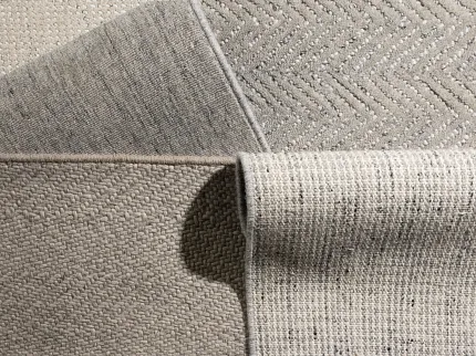 100% Wool Carpet Swatches in Beige, Grey, and Taupe - Textured Patterns Close-up of 100% wool carpet swatches in beige, grey, and taupe with various textures