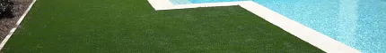 Artificial grass surrounding a swimming pool