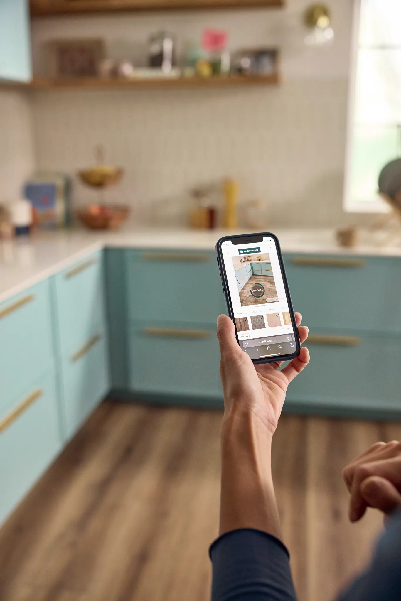 Overhead view of two people selecting flooring samples including carpet, hardwood, and tile on a black table