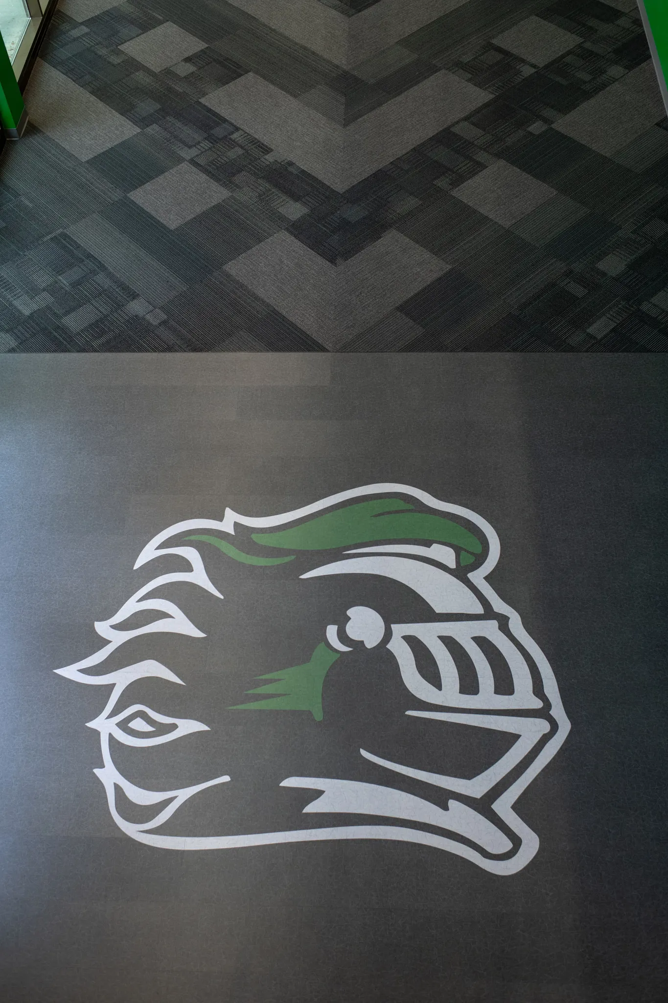 Heavy commercial luxury vinyl tile with custom logo design in an education facility