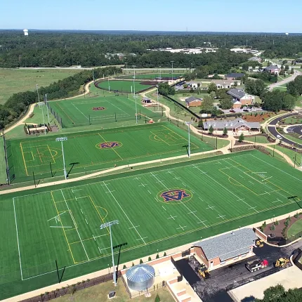 Artificial turf sports fields aerial view Aerial view of sports fields with artificial turf featuring various markings and logos