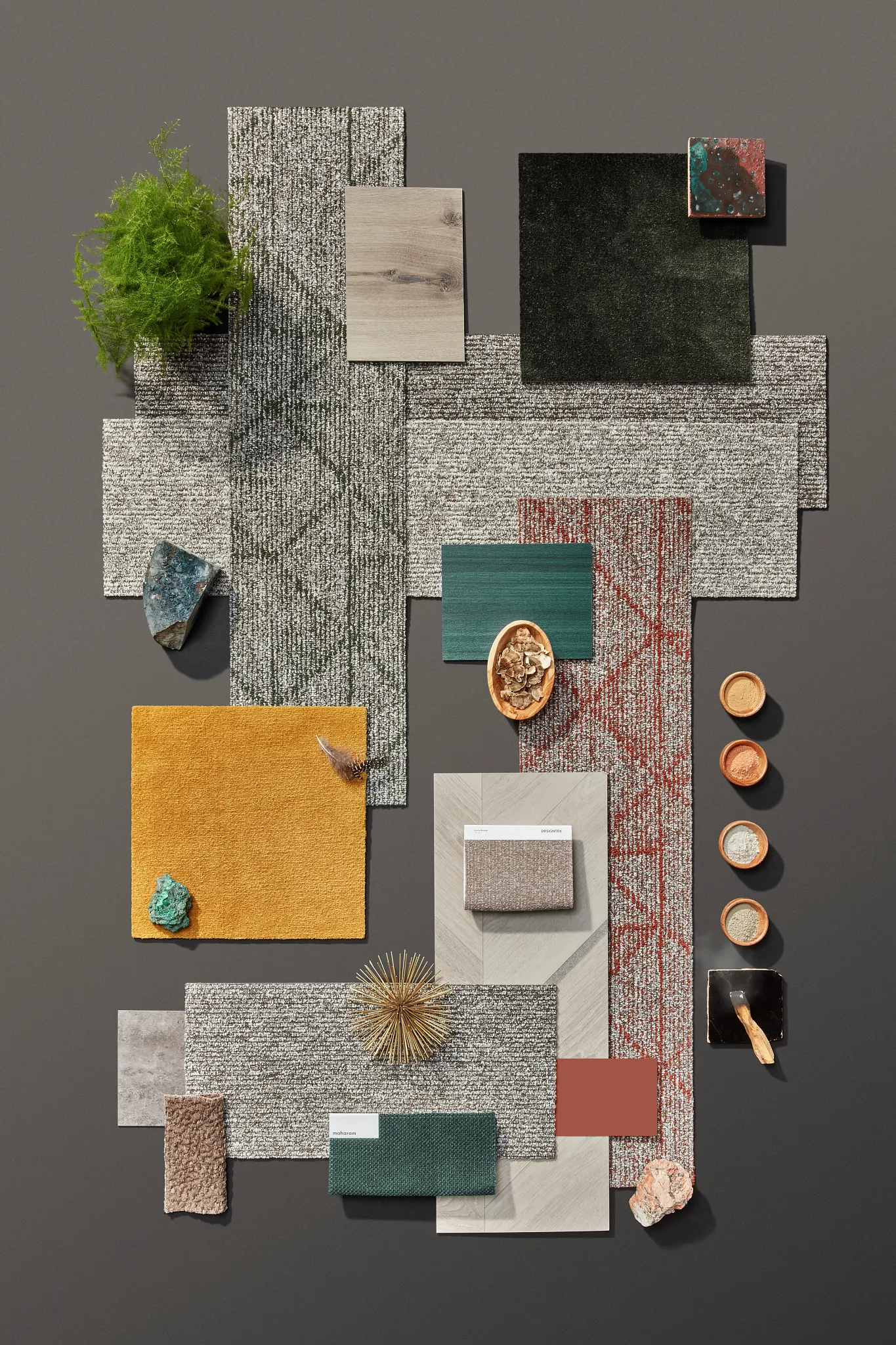 Assorted flooring swatches including green, yellow, and red patterns with various textures and materials
