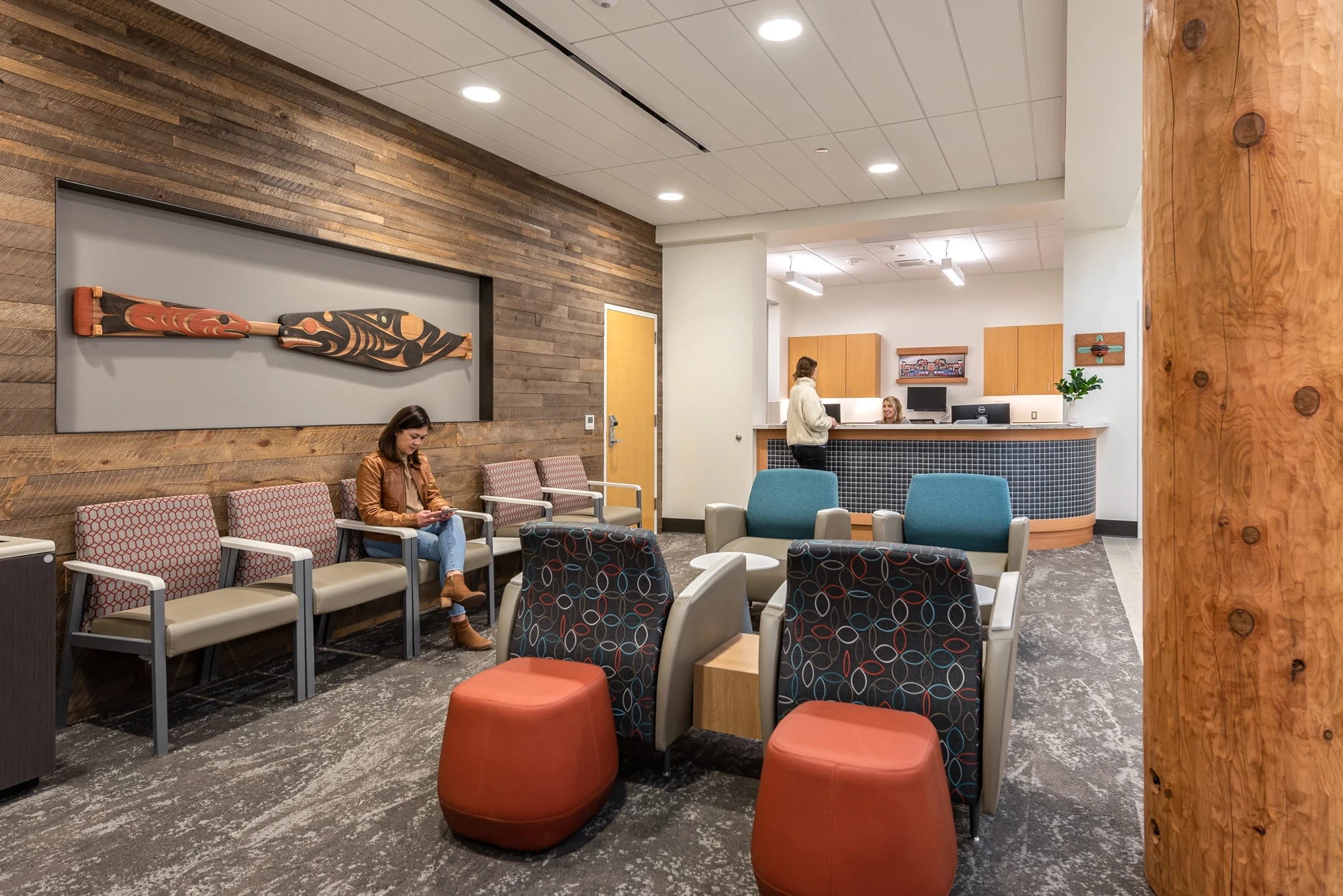 Modern waiting area with textured flooring and wooden wall accents