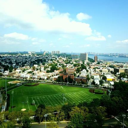 Cityscape with Artificial Turf Sports Field Aerial view of a cityscape featuring a sports field with artificial turf