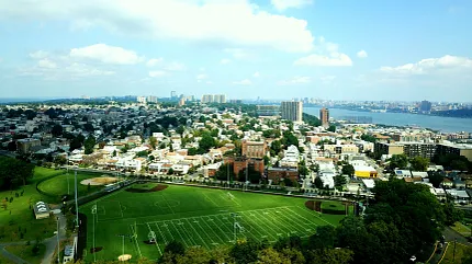 Cityscape with Artificial Turf Sports Field Aerial view of a cityscape featuring a sports field with artificial turf