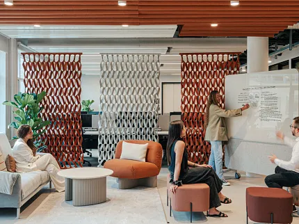 Contemporary office design with chic furniture and accents Modern office space with stylish seating and decorative partitions