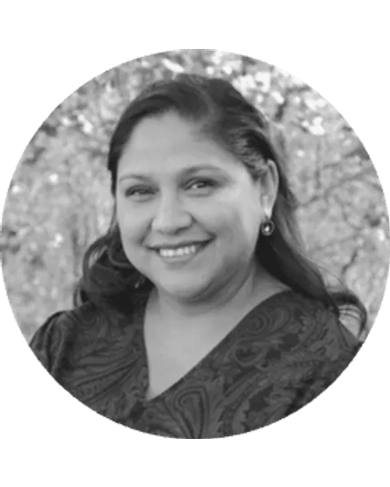 Woman in paisley dress with nature backdrop in black and white image Black and white image of a woman in a paisley-patterned dress with trees in the background