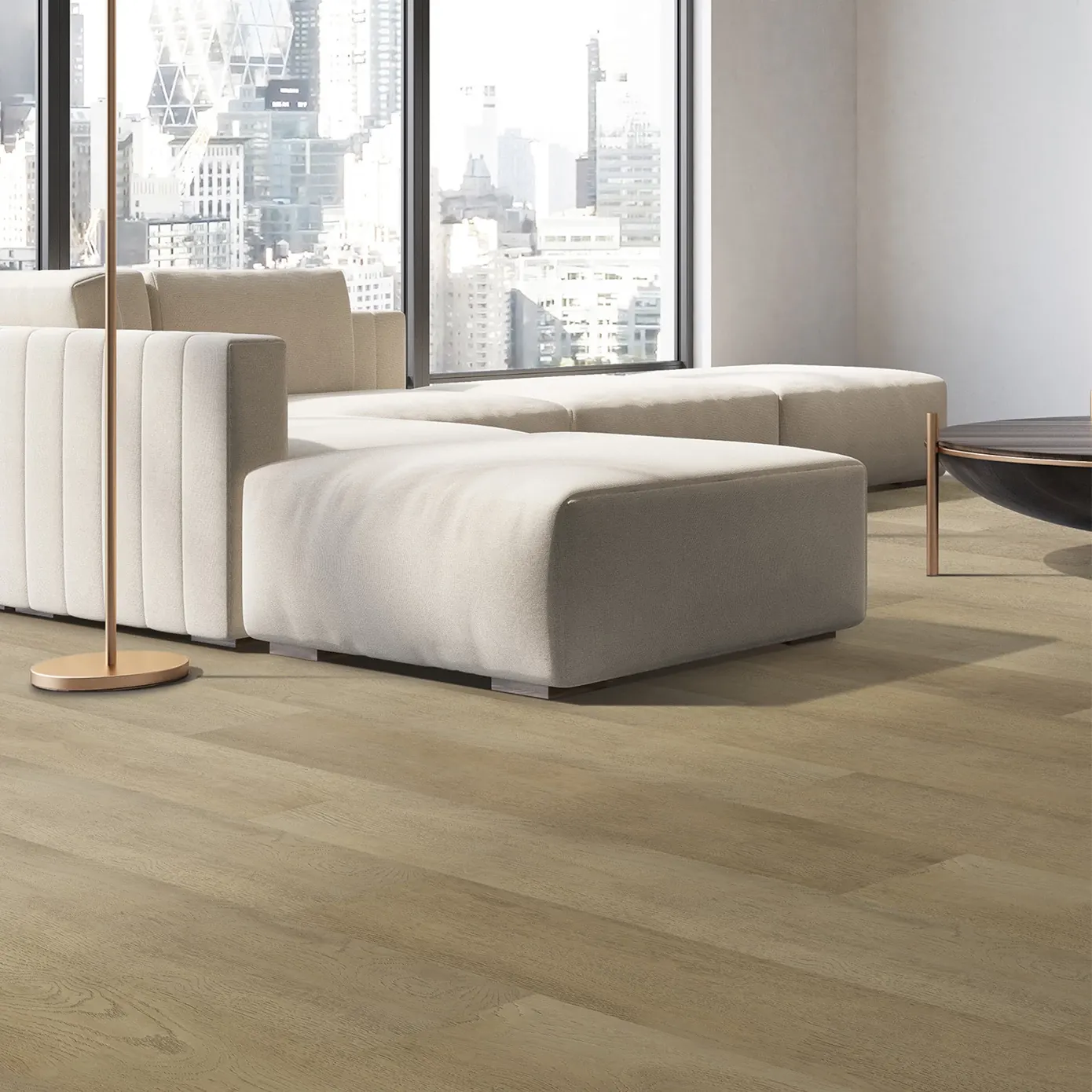 Modern living room with large windows, beige sectional sofa, and light wood flooring