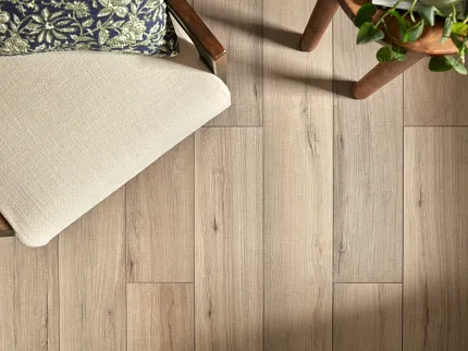 SPC Flooring in Natural Wood Finish - Durable and Easy to Maintain for Everyday Comfort Overhead view of a cozy room with SPC flooring in a natural wood finish, featuring a beige cushioned chair and a small wooden table with a plant, dimensions 48.03x7.08 inches