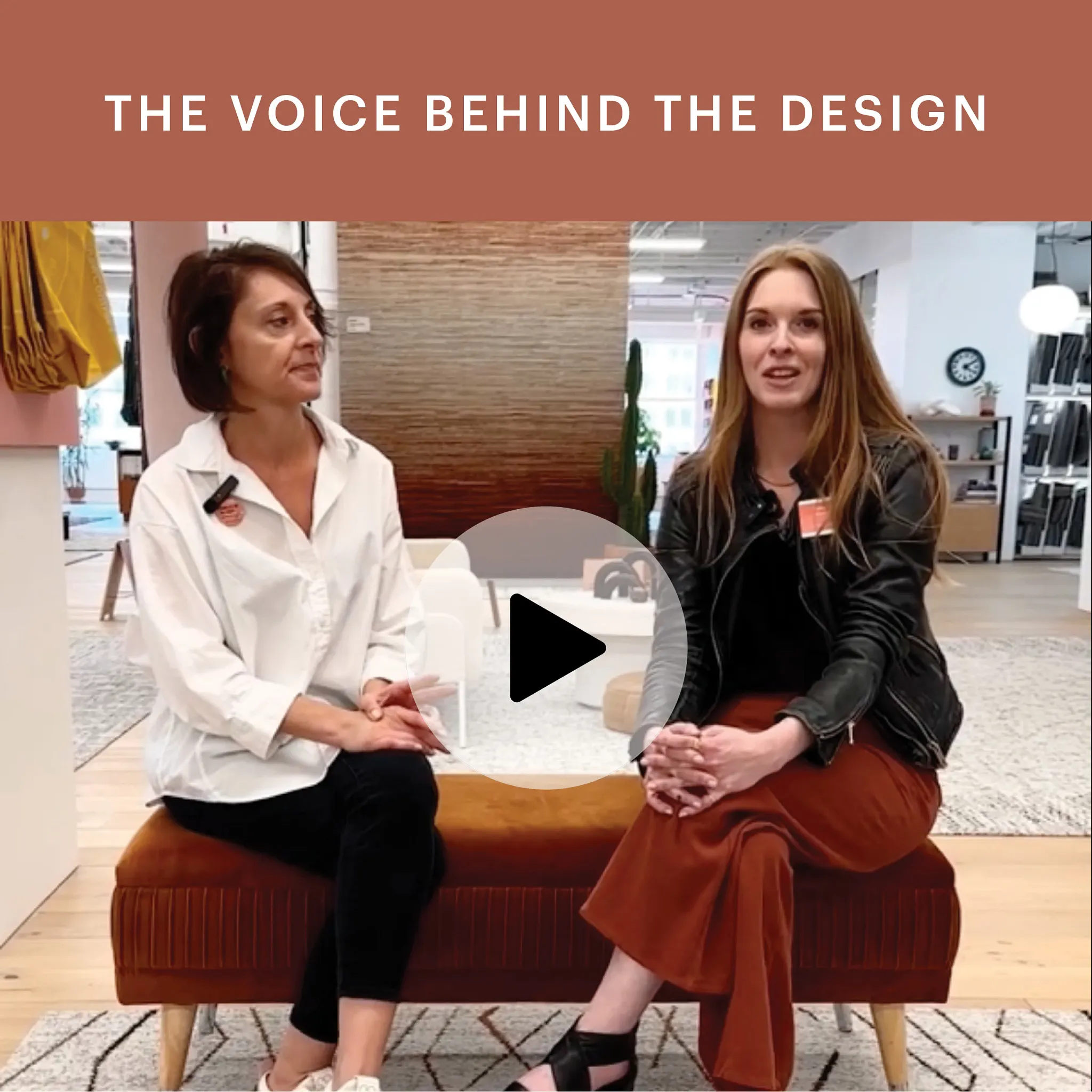 Two women sitting on a brown bench in a modern office setting with a patterned rug and contemporary decor