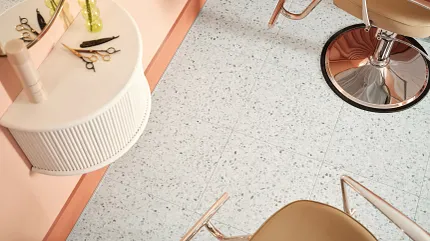 Speckled Luxury Vinyl Tile Flooring in Modern Salon Setting Modern salon interior with speckled luxury vinyl tile flooring and stylish beige chairs