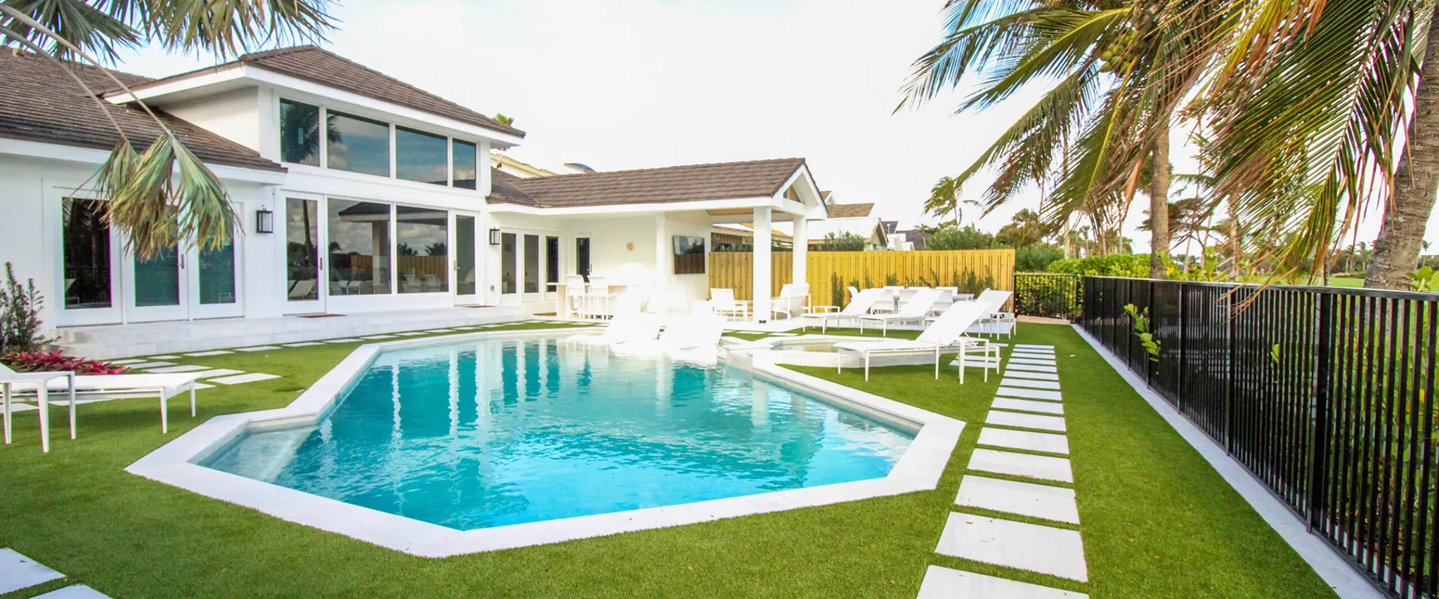 Modern backyard with swimming pool and patio furniture