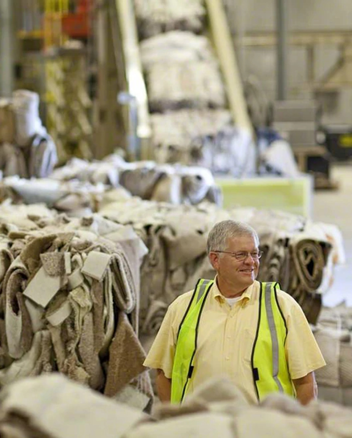 Worker reviewing carpet collected to be recycled