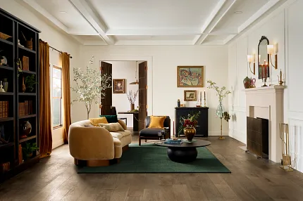 Elegant Living Room with Durable Engineered Hardwood Flooring for Everyday Comfort Cozy living room with engineered hardwood flooring, featuring a beige sofa, dark green rug, and elegant decor