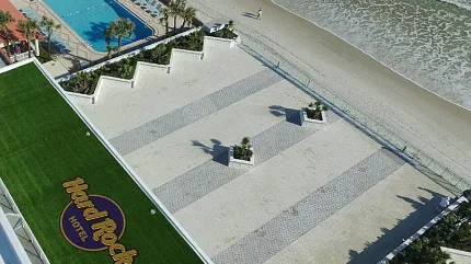 Scenic beachfront at Hard Rock Hotel with poolside amenities Aerial view of Hard Rock Hotel beachfront with pool and ocean