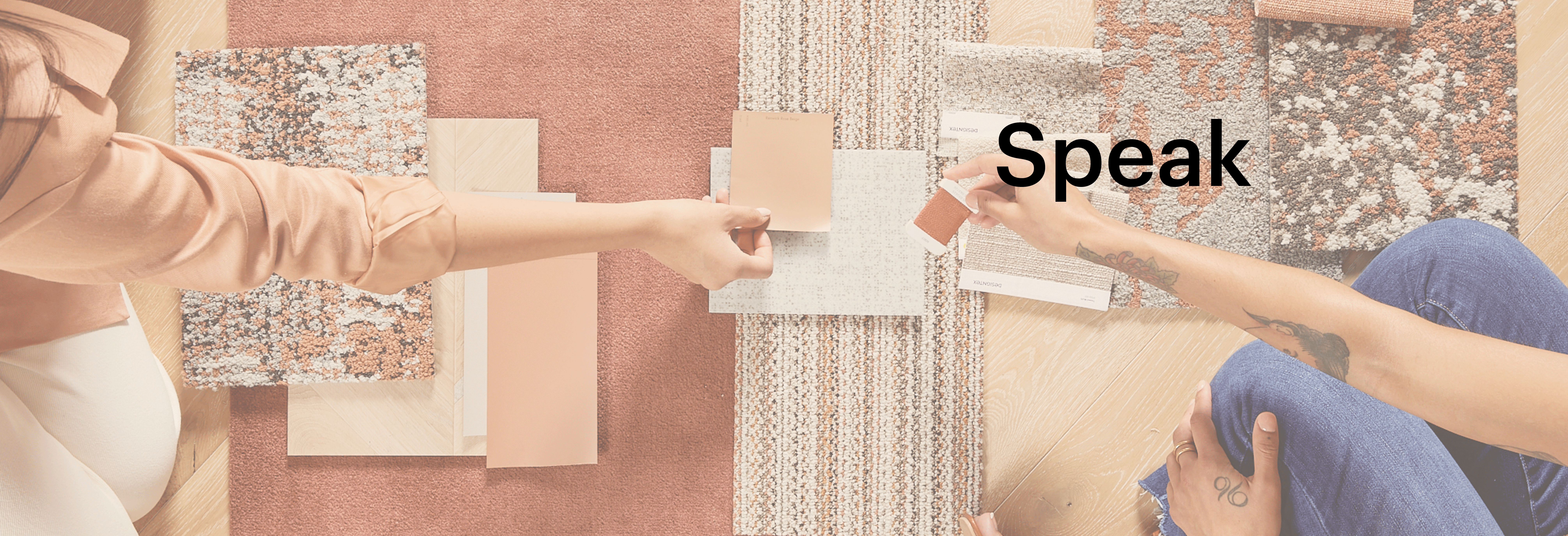 Flooring swatch selection with diverse textures and colors Two people selecting flooring swatches in various colors and textures including peach, beige, and patterned designs