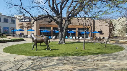 Scenic plaza with art and dining options Outdoor plaza with bronze horse statue and restaurant