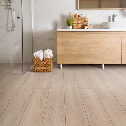 Light Wood Laminate Flooring in Contemporary Bathroom Setting Modern bathroom with light wood laminate flooring and wooden vanity