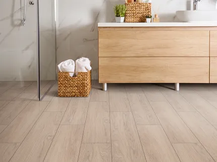 Light Wood Laminate Flooring in Contemporary Bathroom Setting Modern bathroom with light wood laminate flooring and wooden vanity