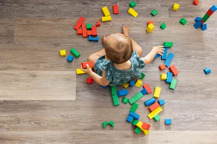 Coretec Residential WPC Wood Look Vinyl Flooring - 48.03x7.13 inch Child playing with colorful blocks on wood look vinyl flooring