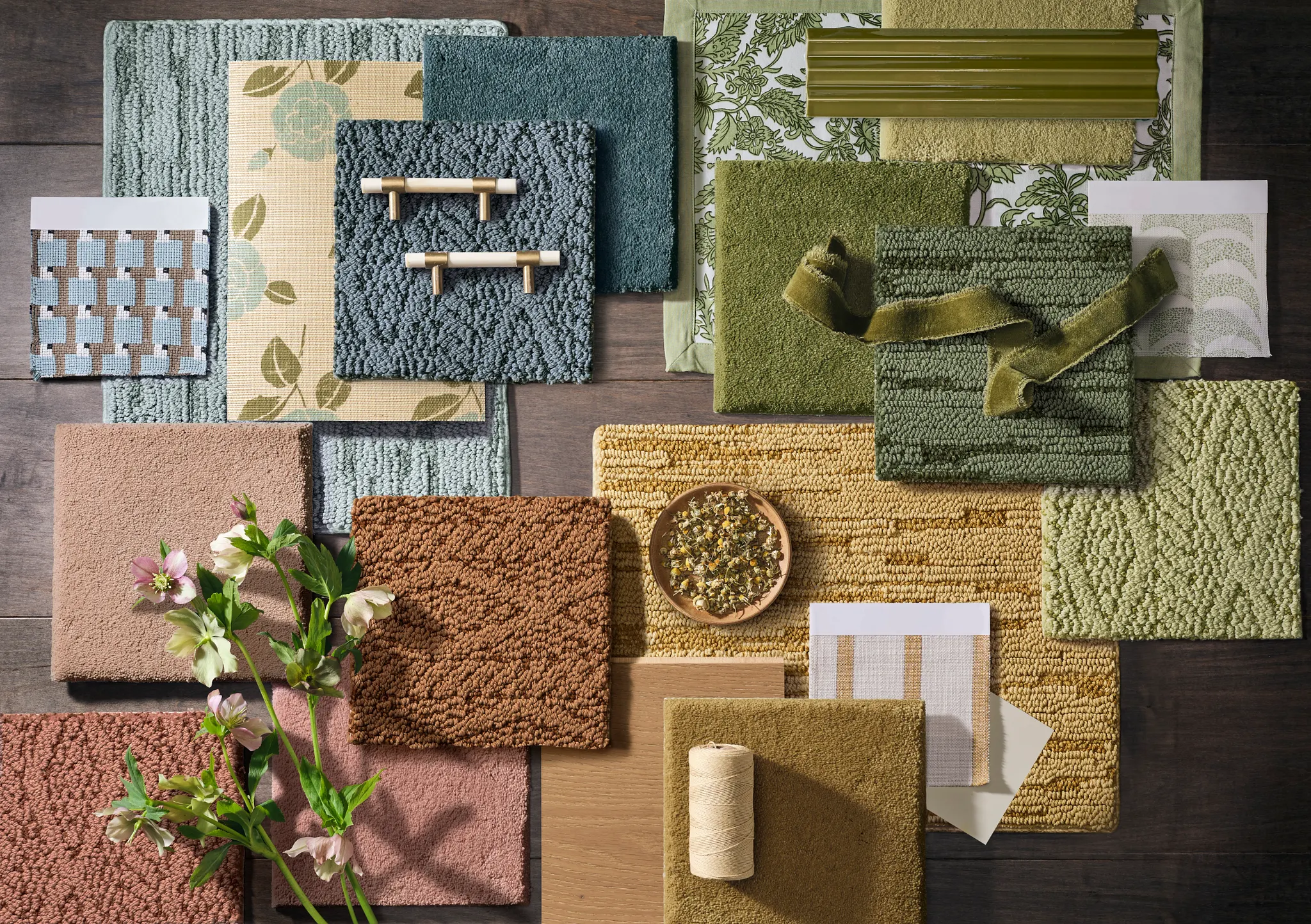 Assorted carpet samples in green, blue, brown, and pink shades