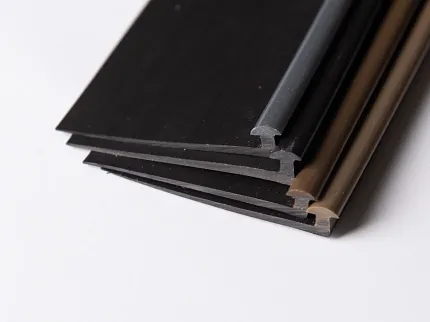 Flooring Trim Pieces in Black, Gray, and Brown Colors Close-up of black, gray, and brown flooring trim pieces