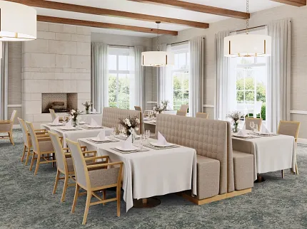 Sophisticated dining room with floral carpet flooring and elegant decor Elegant dining area with floral patterned carpet flooring, featuring beige upholstered chairs and white tablecloths