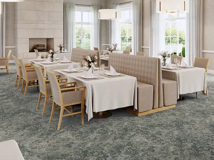Sophisticated dining room with floral carpet flooring and elegant decor Elegant dining area with floral patterned carpet flooring, featuring beige upholstered chairs and white tablecloths