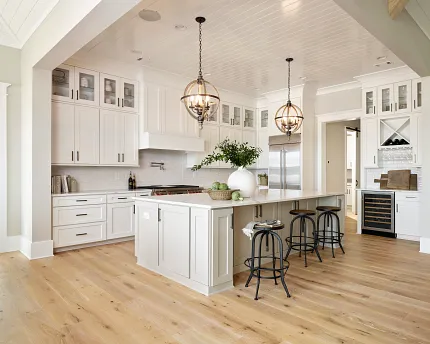 Light Hardwood Flooring in a Contemporary Kitchen Setting Modern kitchen with light hardwood flooring, white cabinetry, and pendant lighting for a warm and inviting atmosphere