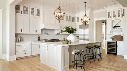 Light Hardwood Flooring in a Contemporary Kitchen Setting Modern kitchen with light hardwood flooring, white cabinetry, and pendant lighting for a warm and inviting atmosphere