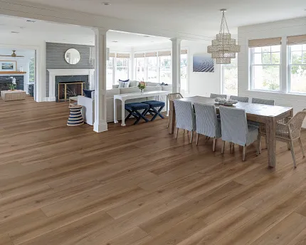 Elegant hardwood flooring in a bright and cozy home setting Spacious living and dining area with natural light and warm-toned hardwood flooring