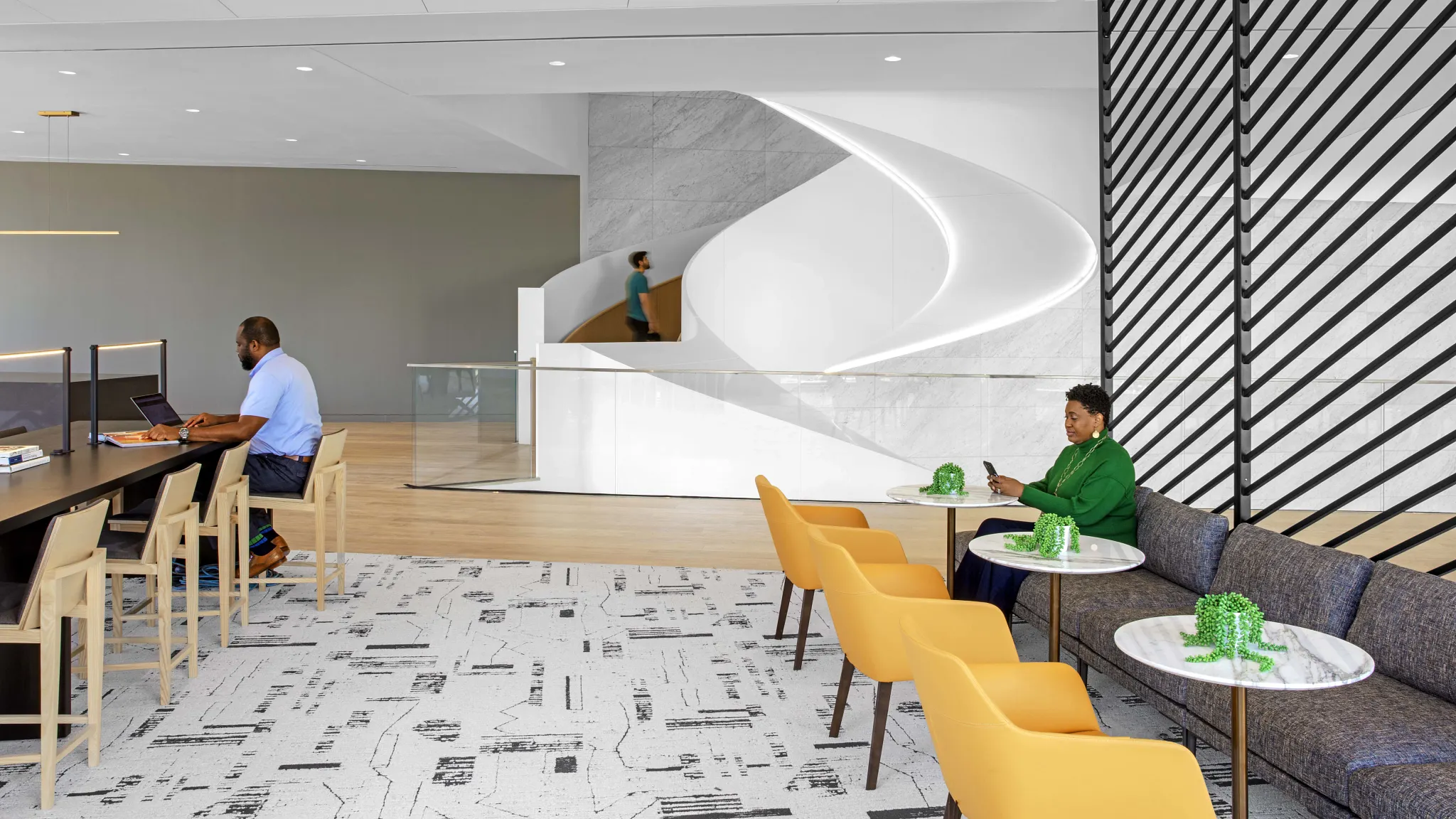 Modern workplace interior with abstract patterned flooring, yellow chairs, and a sleek white reception area