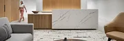 Contemporary Workplace Design with Marble and Wood Elements Modern workplace interior with a marble reception desk, wooden paneling, and contemporary furniture