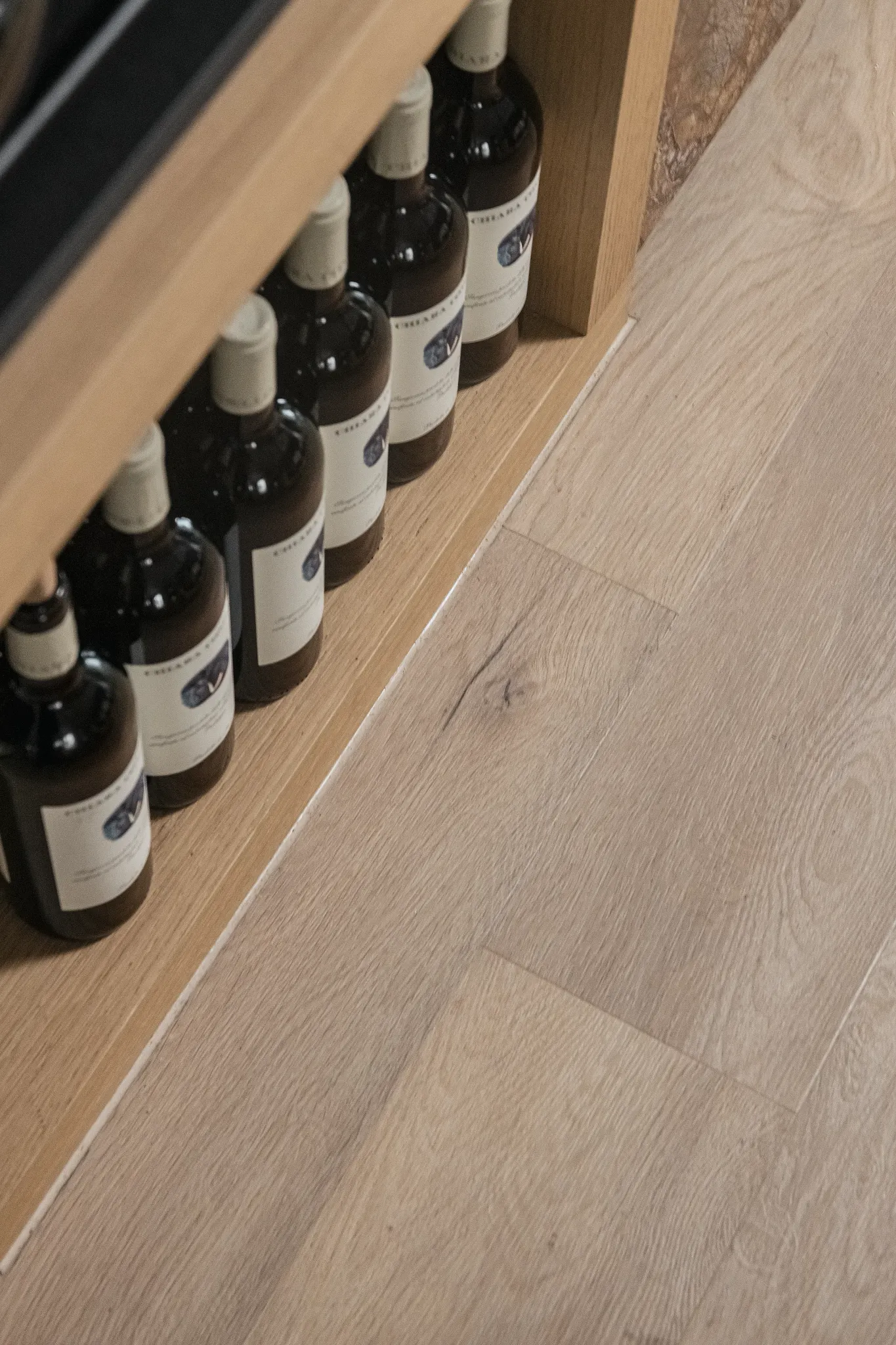 Wood look vinyl flooring with wine bottles on shelf