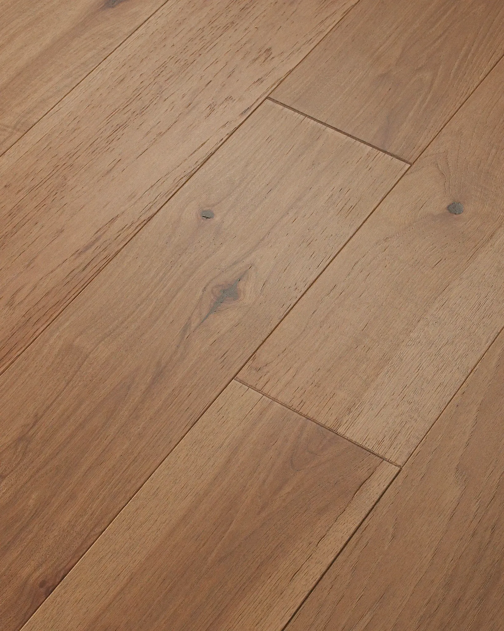 Light brown hardwood flooring with natural wood grain and knots