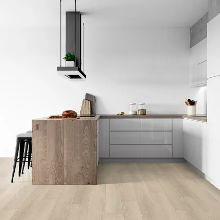 Light Wood Look LVP Flooring in Modern Kitchen Design Modern kitchen with light wood look luxury vinyl plank flooring, featuring sleek gray cabinets and a wooden island.