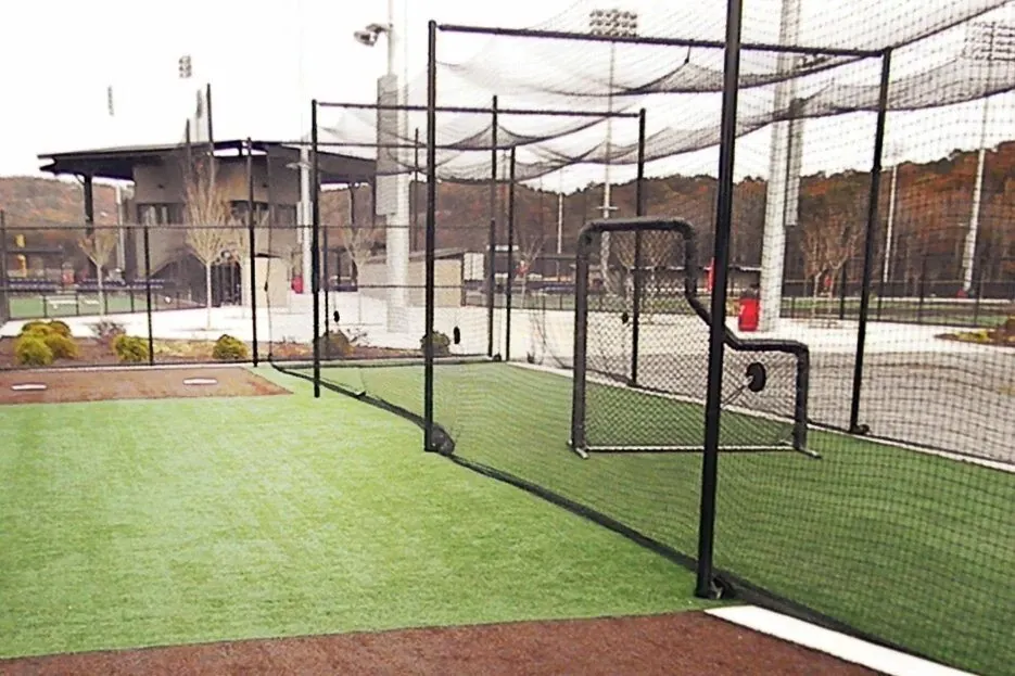 Outdoor sports field with artificial turf and netting