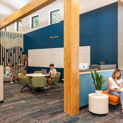 Education Facility with Commercial Carpet Tile Flooring in Library Setting Modern education facility with students in a library setting featuring commercial carpet tile flooring in shades of blue and gray