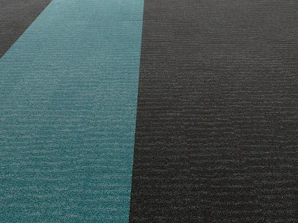 Contemporary office interior with teal and dark gray commercial carpet tile flooring Gravel II in Path + Lichen